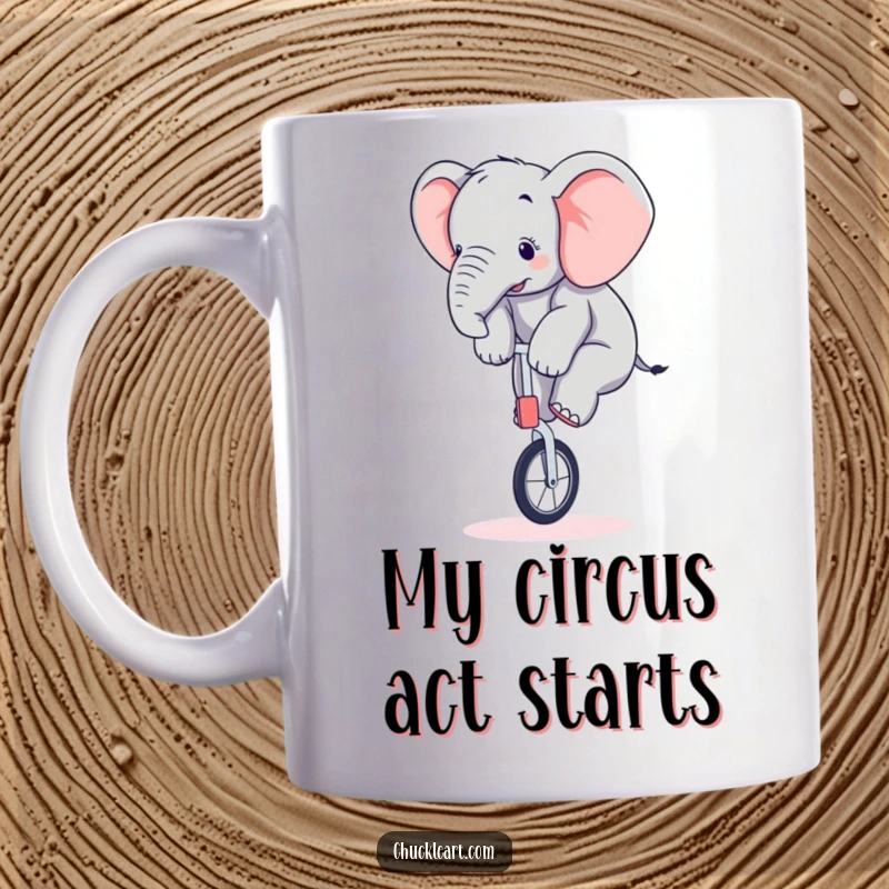 Funny elephant mug showing a clumsy baby elephant struggling to balance on a miniature unicycle, looking bewildered.