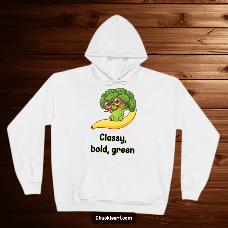 Funny hoodie showing a determined broccoli floret with a monocle, comically trying to ascend a slippery banana peel.