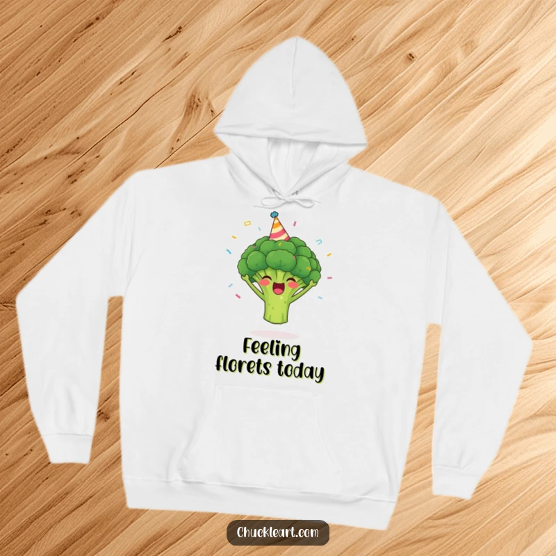 Funny broccoli hoodie depicting a happy broccoli in a party hat with confetti, offering warmth and a humorous vibe.