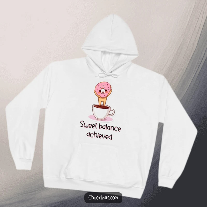 Funny hoodie depicting a donut balancing in a headstand on a coffee cup, great for cozy humor.