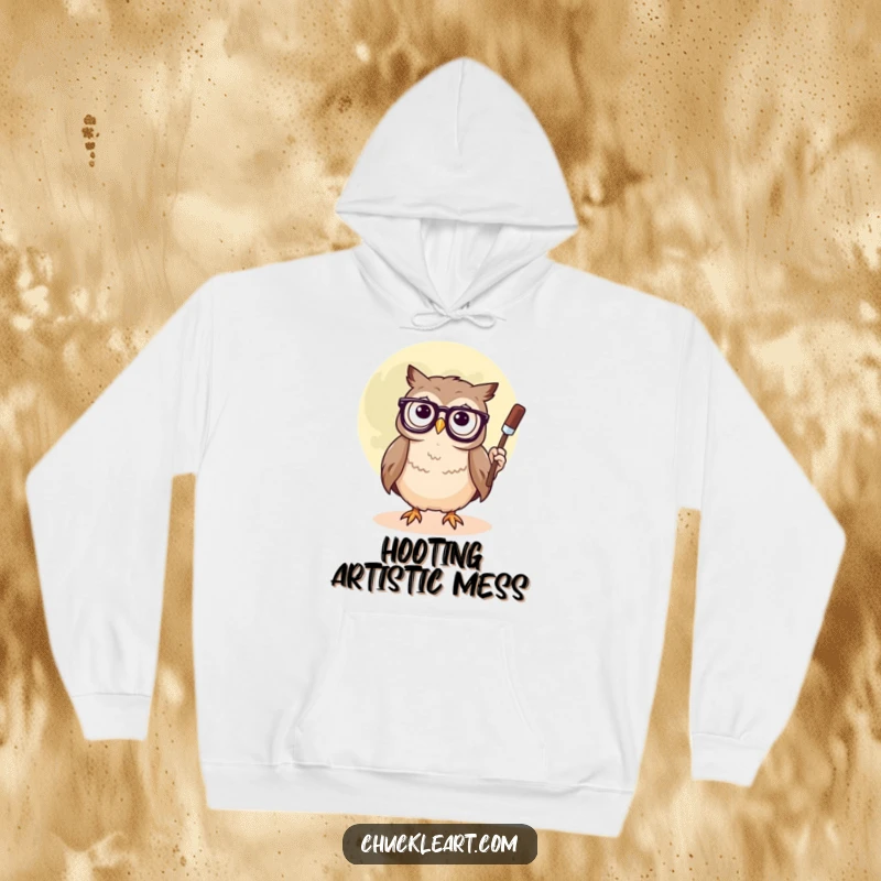 Funny hoodie with a confused owl wearing glasses, focused on painting a smiley face onto the moon, cozy and intellectually amusing.