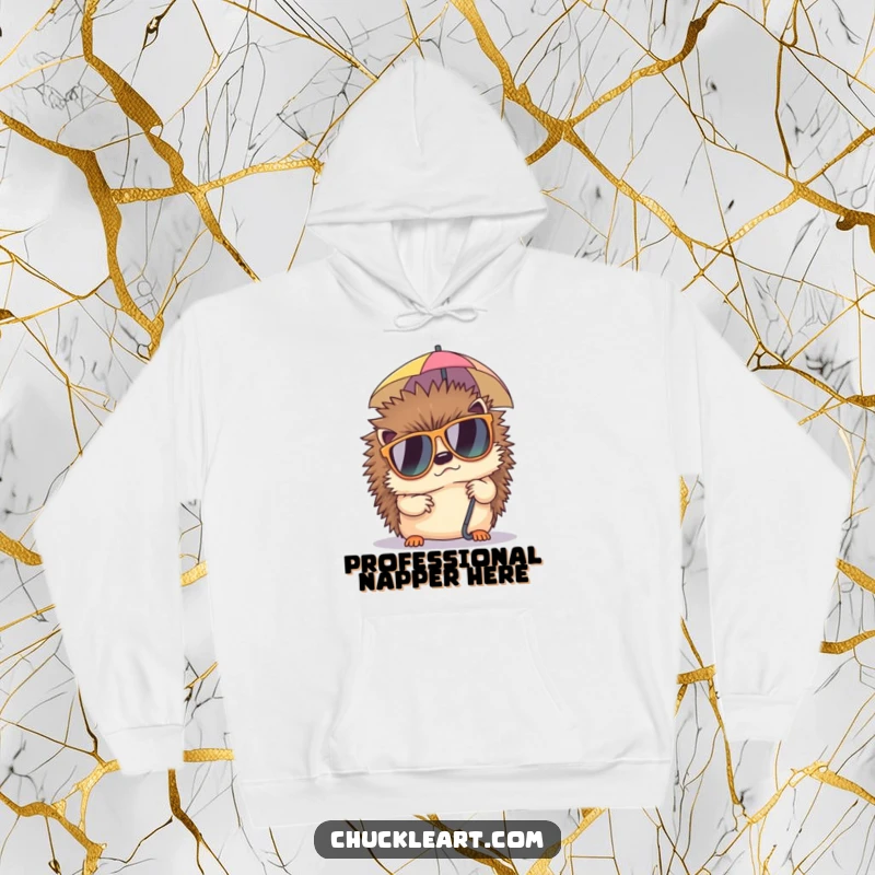 Funny hoodie showcasing a grumpy hedgehog in large sunglasses, napping under a tiny umbrella, perfect for cozy, laid-back humor.