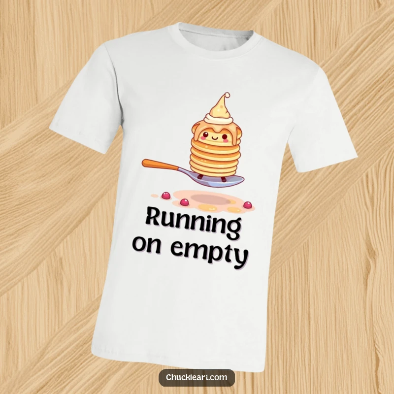 Funny t-shirt graphic of a wobbly pancake stack wearing hats, in a frantic escape from a giant fork.